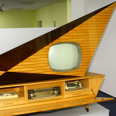 Ein in einem Schrank integrierter Fernseher eines alten Tonmöbels. Im unteren Bereich sind ebenfalls Radio und Schallplattenspieler verbaut.