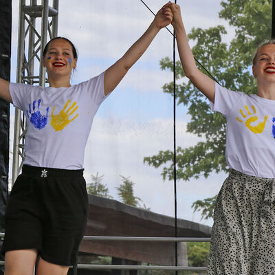 Zwei junge Frauen tanzen beim Ukraine-Fest am Fümmelsee auf der Bühne.
